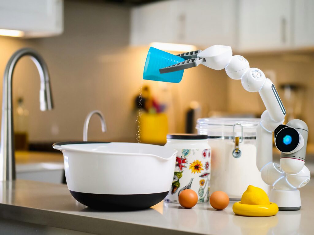 A robot arm adding ingredients in a kitchen.