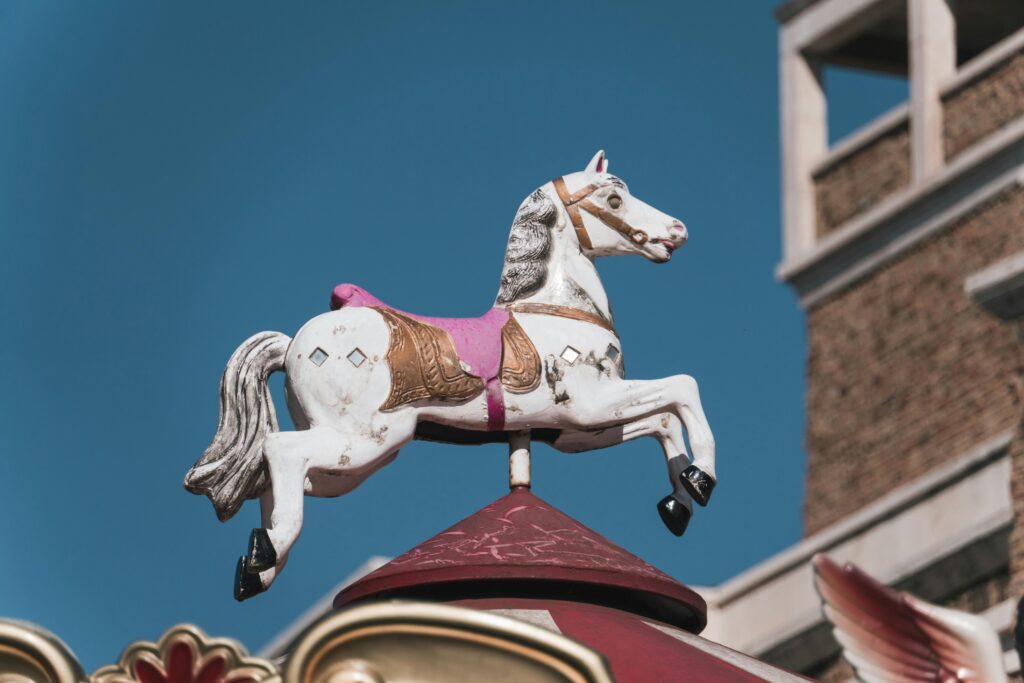 A carousel horse on the top of a carousel