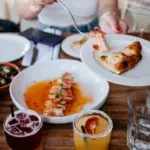 Different plates of food being shared